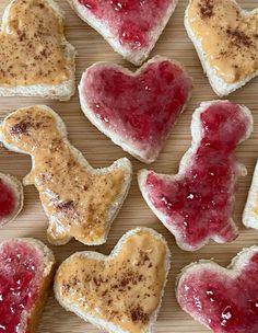 heart shaped cookies with jam on them sitting on a table