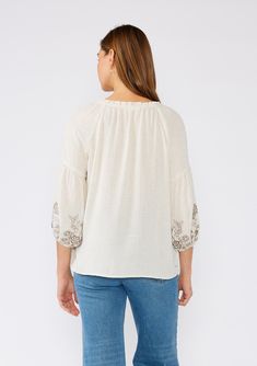 A classic bohemian peasant top is a must-have addition to your spring and summer wardrobe. Featuring an intricate embroidered detail, with a split v-neckline, tassel ties, and exaggerated voluminous 3/4 length sleeves. Try it tucked into denim, or wear it loose over shorts. Linen blend Embroidered Relaxed fit Voluminous 3/4 length long sleeve Elastic cuff Split v-neckline with tassel ties Ruffled neckline Flowy bohemian peasant top Model is 5'9, wearing a size S.Style: I-13851W-RRR Bohemian V-neck Blouse With Embroidered Hem, Bohemian V-neck Embroidered Top, Folk Style V-neck Blouse With Embroidered Neckline, Summer Embroidered V-neck Peasant Top, Spring Folk Style V-neck Peasant Top, Spring Bohemian Top With Embroidered Hem, Spring Bohemian Blouse With Embroidered Hem, Fall Bohemian Blouse With Embroidered Hem, Bohemian Fall Blouse With Embroidered Hem