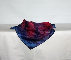 This square silk bandanna measures 22 by 22 inches or 55 by 55 centimeters. It has hand rolled and hand stitched edges into which I sew my own label. It will tie around the neck or can be rolled around the head. This bandanna is ponge 5 silk.  I sprayed the silk with red and navy blue steam fix dyes. I then dropped salt onto the wet dye. When heat is applied the salt pulls the dye into a unique pattern. The bandanna is then steamed to fix the dye. The bandanna is hand washable and laundry instru Laundry Instructions, Long Silk Scarf, Square Silk Scarf, Scarf Silk, Hand Roll, Blue Square, Silk Scarves, Bandanas, Hand Stitched