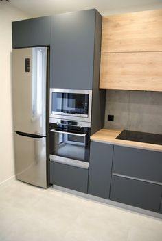 a kitchen with gray cabinets and stainless steel appliances