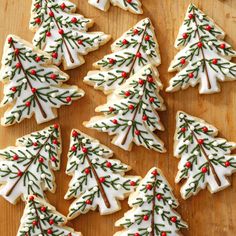 decorated christmas tree cookies on a cutting board