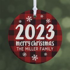 a red and black ornament with the words merry christmas in white on it