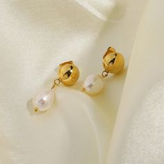 Indulge in the classic beauty of Pearl Drop Earrings, elegantly crafted in 18k gold plating. These earrings feature lustrous pearls that gracefully dangle, adding a touch of timeless sophistication to any attire. Classic Pear-shaped Gold Earrings, Gold-plated Dangle Pearl Earrings, Gold-plated Gold Pearl Dangle Earrings, Gold Plated Gold Pearl Dangle Earrings, Yellow Gold Plated Teardrop Pearl Earrings, Elegant 14k Gold Filled Pearl Drop Earrings, Elegant 14k Yellow Gold Filled Teardrop Earrings, Gold Teardrop Earrings With Pearl Drop For Formal Occasions, Gold Pearl Earrings In 14k Gold Filled