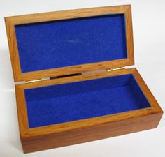 an open wooden box with blue felt inside