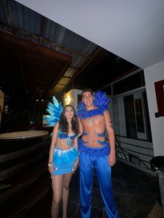 two people dressed in costumes standing next to each other