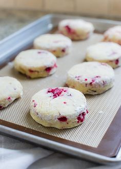 freshly baked raspberry shortbread cookies on a cookie sheet ready to be baked