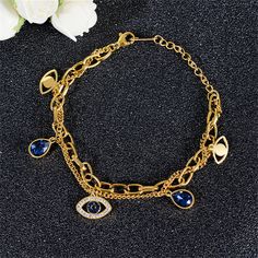 this 18k gold-plated layered bracelet features station details of cubic zirconia, crystal and devil eyes. 6.69" L 0.55" W x 0.39" H Lobster claw clasp 18k gold-plated stainless steel / crystal / cubic zirconia Devil Eyes, Layered Bracelet, Devil Eye, Layered Bracelets, Lobster Claw, Cubic Zirconia, 18k Gold, Gold Plate, Plating