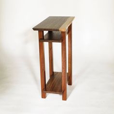 a small wooden table sitting on top of a white floor