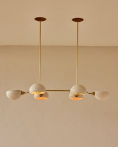 three lights hanging from the ceiling in a room