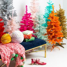 brightly colored christmas trees and presents on a bench