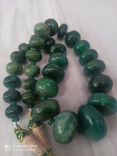 17 '' AAA 922 Caret Emerald Beryl Smooth Rondelle 13- 25MM Beads Gemstone Necklace with adjustable code Stone : Emerald Beryl Shape :- Rondelle Necklace - 17 inch 1 line string Size :- 13mm to 25mm Weight :- 922 carat Quality - AAA Polish :- Handmade color - green makes a great gift for your loved ones. It is known as the 'love stone' as the message it emits is the strong vibration of unconditional love, joy, warmth and healing. As quartz crystals are profound amplifiers of energy, it may help t Handmade Adjustable Emerald Necklace With Round Beads, Handmade Adjustable Beaded Emerald Necklace, Handmade Adjustable Emerald Necklace, Adjustable Jade Necklace With Large Beads, Adjustable Beaded Necklace With Oval Natural Stones, Spiritual Emerald Beaded Necklace With Round Beads, Adjustable Jade Beaded Necklace With Faceted Beads, Spiritual Beaded Emerald Necklace With Round Beads, Jade Necklaces With Large Round Beads