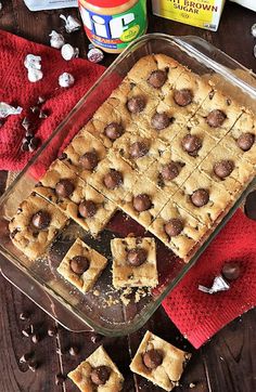 chocolate chip cookie bars sitting on top of a table next to other cookies and marshmallows