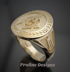 Made entirely in the U.S.A. Ring Details~ Bold - Handsome - Exquisitely Finished - Original The newest addition to our Prestige Collection, this gold version of our moral compass ring is sure to stand out. The top prominently features the square and compass with the four directions around the outer edge. The side windows display the symbolic trowel and level on a textured background. Hand finished to perfection, the high polish creates a contrast against the sandblasted background. All creations Gia Certified Gold Promise Ring, Gold Signet Ring With Maker's Mark, Gold Round Signet Ring With Maker's Mark, Classic Gia Certified Signet Ring For Formal Occasions, Classic Formal Jewelry With Compass Design, Luxury Anniversary Signet Ring With Maker's Mark, Anniversary Jewelry Ring With Compass Design, Timeless Round Compass Design Jewelry, Symbolic 14k Gold Engraved Ring With Polished Finish