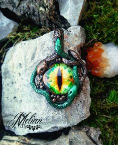 Medusa's Eye pendant with green and bronze snakes. Handmade with lots of details, this powerful necklace will surely leave everyone petrified.    #Medusa #EvilEye #SnakeJewelry #MedusaNecklace #Handmade #Fimo Handmade Mystical Green Jewelry, Mystical Handmade Green Jewelry, Handmade Green Mystical Jewelry, Green Handmade Mystical Jewelry, Green Fantasy Jewelry For Festival, Fantasy Green Jewelry For Festival, Green Fantasy Festival Jewelry, Green Amulet Necklace Collectible, Collectible Green Amulet Necklace