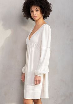 Designed in a lightweight linen blend, this retro-inspired mini dress is an instant bohemian classic. Featuring long voluminous sleeves, an adjustable tie-back detail, and delicate pintuck details. An effortless style that pairs well with a simple leather sandal. Linen blend Relaxed fit Long voluminous sleeve Elastic wrist cuff Mini length V-neckline Adjustable tie-back detail Half elastic waist at the back Empire waist Pintuck details Classic bohemian mini dress Model is 5'9, wearing a size S.S Chic Mini Dress With Smocked Back And Balloon Sleeves, Chic Spring Linen Mini Dress, Chic Linen Mini Dress For Spring, Chic Midi Dress With Bishop Sleeves For Brunch, Spring Brunch Dress With Bishop Sleeves, Spring Dresses For Brunch With Bishop Sleeves, Spring Daywear Puff Sleeve Dress With Bishop Sleeves, Feminine Pleated Sleeve Mini Dress For Brunch, Spring Puff Sleeve Dress With Bishop Sleeves For Daywear