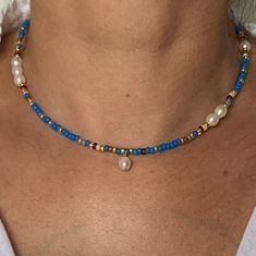 This 14K GF blue seed bead and freshwater pearl necklace is a story of joy near by the water .. Close your eyes... Are you there ? Wear it on its own for a sleek style, or as an accumulation for a more bohemian touch. * Materials :  14K GOLD FILLED clasp and extension chain. Gold-filled  is a thick layer of gold on metal, a higher-quality material than gold-plated. High quality glass seed beads  Natural freshwater selected pearls size about 7x6 mm * Size: The necklace is a choker measuring 39 cm + a 3 cm extension chain. * Customization If you'd like a different length or a particular color, write me a message. I'll be happy to realize your unique design!   * Delivery The parcel is shipped within 1 to 2 days by 📩 TRACKED PARCEL SERVICE 📩 Your jewelry comes in a pretty little velvet pouch Cheap Blue Beaded Necklaces With Tiny Beads, Handmade Blue Pearl Necklace Gift, Handmade Blue Pearl Necklace For Gift, Handmade Blue Pearl Necklace, Blue Bohemian Jewelry With Pearl Charm, Bohemian Blue Jewelry With Pearl Charm, Blue Bohemian Pearl Necklaces, Blue Bohemian Pearl Necklace, Blue Pearl Beaded Necklaces For Beach