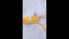 the yellow thread is being used to weave fabric