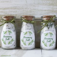 three glass jars with rosemary salt in them