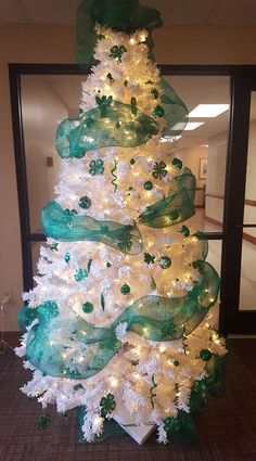 a white and green christmas tree with lights