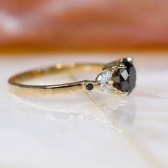 Beautiful and Classy Round Natural Black Diamond Set in 14K Ring With 4 Sparkling White Marquise diamond side stones. Perfect Art Deco Black and White Engagement Ring   ---------Item Specifications------- Total Carat Weight:  1.20 Carats 14K Yellow Gold Size: Resizable Main Diamond: Shape: Round Weight: 1 Carat Measurements: 6.2+ mm Color: Fancy Black (Enhanced)  Clarity: Opaque Grade: AAA Graded Side Diamonds: Shape: Marquise Weight: 0.20 Carats Color: White Clarity: VS-SI Engagement shop - www Engagement Ring Black, White Engagement Ring, Black Diamond Earrings Studs, Nature Engagement Ring, Black Diamond Necklace, Black Diamond Studs, Black Diamond Jewelry, White Diamond Earrings, Black Diamond Earrings