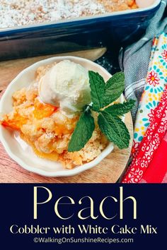 peach cobbler with white cake mix on a wooden table next to a baking dish