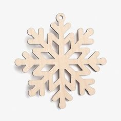 a wooden snowflake ornament on a white background