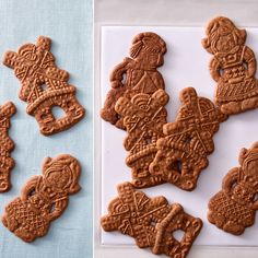 some cookies are on a white plate and one is decorated with an image of soldiers