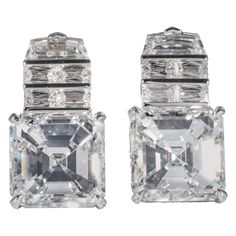 These earrings are offered by Shreve, Crump & Low. These exceptional diamond drop earrings incorporate two GIA certified asscher cut diamonds, one weighing 9.19 carats with a color and clarity of F VVS1 (GIA report no. 5191337302), the other weighs 9.02 carats with a color and clarity of G VS1 (GIA report no. 1192389989). The asscher cut diamonds are set with 2 step cut trapeziods, and 8 baguette cut diamonds (4 per earrings) weighing a total of 3.32 carats with a color and clarity of F-G VS1-VS Three Stone Engagement Rings Emerald, Large Gold Earrings, Princess Cut Earrings, Gold Diamond Drop Earrings, Rings Emerald, Oval Cut Diamond Rings, Big Engagement Rings, Cushion Cut Diamond Ring, Emerald Cut Diamond Ring