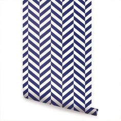 a blue and white wallpaper with chevroned stripes on the bottom half of it