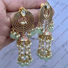 A Premium quality fusion meenakari pearl tassels chain earrings with the silver foiled kundan. Light Weight Earrings length: Approx. 3.5” Push - back closure Antique Gold plated on high-quality brass as base metal Availability: In-Stock *Color may vary slightly due to light condition & photography. Jewelry Care: Keep away from moisture. Allow perfumes and lotion to dry before wearing. Store in jewelry pouch. Clean only with soft lint free cloth. Festive Fusion Danglers With Dangling Beads, Metal Tassel Earrings For Wedding, Fusion Kundan Chandelier Earrings With Latkans, Fusion Style Kundan Chandelier Earrings With Latkans, Kundan Fusion Dangle Jhumkas, Fusion Style Kundan Dangle Jhumkas, Fusion Style Dangle Jhumkas With Latkans, Diwali Fusion Style Chandelier Earrings With Latkans, Fusion Style Latkans Chandelier Earrings For Celebration