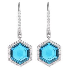 This is Swiss Blue Topaz Drop earrings in hexagon briolette shape. The earrings is elegant and can be worn for many occasions. The Swiss Blue Topaz around the Earrings add to the beauty and elegance of the Earring. Swiss Blue Topaz Drop Earrings in 18Karat White Gold with White Diamond. Swiss Blue Topaz: 7.61 carat, 10X10mm size, Hexagon briolette shape. White Diamond: 0.13 carat, 1.30mm size, round shape, G color, VS clarity. White Diamond: 0.22 carat, 1.00mm size, round shape, G color, VS clarity. Gold: 5.26g, 18Karat White Gold. Lever Back E583 Blue Topaz Stone, Naha, Topaz Stone, Swiss Blue Topaz, Amethyst Earrings, London Blue Topaz, Modern Earrings, Modern Jewelry, White Diamond