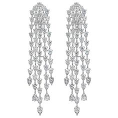 This versatile and stylish chandelier earrings showcasing five-rows of round brilliant pear shape illusion diamonds set in an elegant chandelier waterfall design and made in 18k white gold. Diamonds weigh 9.35 carats total and are approximately F-G color, SI in clarity. Style available in different price ranges. Prices are based on your selection. Please contact us for more information. Expensive Earrings, Ruby Diamond Necklace, Diamond Chandelier Earrings, Diamond Chandelier, Vintage Drop Earrings, Bling Earrings, Bridal Necklace Set, Book Character, Luxury Jewellery