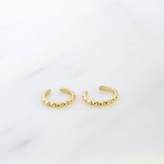 "Simple and dainty ear cuff - a perfect piece to add a subtle detail to the top of your ear without the need for a piercing. Both tiny and versatile, this delicate ear cuff is perfect to mix and match with other earrings. ♦ Sold individually (1 ear cuff) or as a pair (2 ear cuffs) * D E T A I L S * ∙ Material: .925 Sterling Silver or 18K Gold Plated over .925 Sterling Silver ∙ Diameter: 8mm ∙ Fit: Slide ear cuff onto the top of your ear, then move to the desired position & squeeze gently for a s Trendy Gold Single Ear Cuff, Trendy Adjustable Gold Cartilage Earrings, Trendy Gold Pierced Ear Cuff, Trendy Nickel Free Gold Piercings, Trendy Nickel-free Gold Piercings, Adjustable Gold Pierced Ear Cuff, Trendy Gold Tarnish-resistant Piercings, Trendy Gold Piercings, Adjustable Gold Nickel-free Ear Climbers