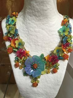 Dripping with colorful hand-painted flowers and glass beads, what a perfect necklace to make you feel like your on a holiday in Havana. This necklace has multi colored flowers of turquoise, yellow, orange and red. A unique and bright fun color combo. It measures almost 20 inches with a 4 inch extender so as you may adjust the length as needed. We use findings that are nickel free. This is a hand beaded piece of jewelry. All the work is hand sewn or wired without the use of glue. This heirloom qu Vibrant Rainbow Jewelry With Colorful Design, Whimsical Multicolor Flower Jewelry, Multicolor Flower Necklace With Flower Decoration, Multicolor Hand Painted Beaded Bohemian Necklace, Handmade Vibrant Multicolor Jewelry, Multicolor Hand Painted Bohemian Beaded Necklace, Bohemian Multicolor Hand Painted Beaded Necklaces, Vibrant Multicolor Handmade Jewelry, Multicolor Flower-shaped Jewelry With Flower Decoration