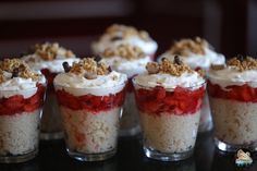 several desserts are arranged in small cups on a table