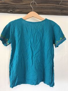 This top is in great condition and it's super soft cotton with stunning floral embroidery. It's best fitted for a 4-6 year old with measurements provided in the photos for an accurate fit. It's the perfect little hippie top to tuck into ol' Levis or bloomers ✌🏽 (5) Spring Bohemian Crew Neck Blouse, Spring Bohemian Top With Embroidered Hem, Bohemian Embroidered Relaxed Fit Blouse, Bohemian Tops With Embroidered Hem In Relaxed Fit, Bohemian Tops With Embroidered Hem And Relaxed Fit, Spring Bohemian Blouse With Embroidered Hem, Bohemian Short Sleeve Tops For Spring, Peasant Floral Embroidered Top For Beach, Embroidered Bohemian Peasant Top With Relaxed Fit