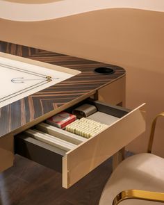 an office desk with a drawer that has some items in it and a keyboard on top