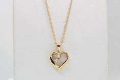 "Experience the enduring charm of our 14K Yellow Gold Heart Pendant, adorned with .03 carats total weight of Lab Diamonds, and complete with an 18\" Chain. This exquisite piece is skillfully handcrafted by our artisanal goldsmith at Jewelry By You." Formal Diamond Heart Charm Jewelry, 14k Gold Heart Pendant Diamond Necklace For Anniversary, Classic Heart Pendant Necklace With Birthstone, Heart-shaped Yellow Gold Diamond Necklace, Heart Shaped Yellow Gold Diamond Necklace, Classic Heart Cut Birthstone Necklace, Classic 14k Gold Open Heart Necklace, Fine Jewelry 14k Gold Heart Pendant Diamond Necklace, Classic Diamond Jewelry With Heart Charm