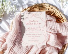 a bridal shower is in a wicker basket next to some baby's breath flowers