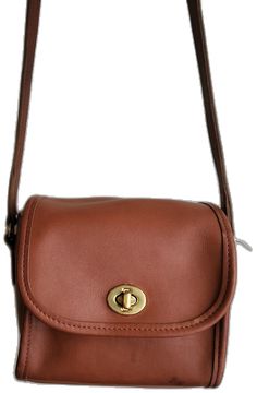 Classic Saddle Bag With Adjustable Strap For On-the-go, Classic Crossbody Saddle Bag For On-the-go, Classic Soft Leather Saddle Bag For On-the-go, Classic Brown Crossbody Flap Bag, Classic Everyday Crossbody Saddle Bag, Brown Saddle Shoulder Bag With Turn-lock Closure, Classic Crossbody Saddle Bag With Adjustable Strap, Classic Formal Bag In Brandy Color, Classic Brandy-colored Formal Bag