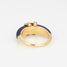 Vintage "Double C" Cartier diamond ring crafted in 18k yellow gold.    Diamonds total an estimated 0.15 carats (estimated at G-H color and VS2-SI1 clarity). Lapis lazuli tapers and measures from 6mm to 4.5mm. Note: some wear to the lapis (surface abrasions) and a small fissure underneath the CC logo (visible under a 10x loupe).    The elusive 'Double C' ring is a classic made by Cartier in the 1970s. Diamonds adorn the 'CC' motif, perched upon rich cobalt blue lapis lazuli. The ring is great worn alone or stacked with your fine jewelry from any era and would also make a unique choice as an alternative wedding ring. The intertwining 'Cs' make a nice representation of a couple joining together as one. The ring does not come with Cartier papers or a box.   The ring is in good condition and wa Gold Cartier Diamond Ring, Cartier Yellow Gold Diamond Ring For Anniversary, Cartier Gold Ring With Single Cut Diamonds, Cartier Yellow Gold Diamond Rings, Gold Cartier Diamond Ring For Anniversary, Cartier Gold Diamond Ring For Anniversary, Anniversary Gold Diamond Ring By Cartier, Classic Cartier Rings With Prong Setting, Classic Cartier Gold Diamond Ring