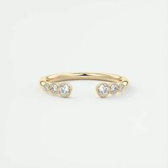 a gold ring with three diamonds on it