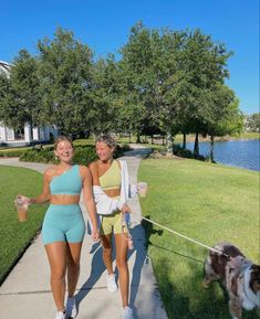 two women walking their dog on a leash