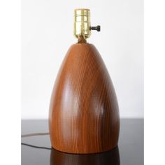 a wooden table lamp with a metal base and a light bulb on the top of it