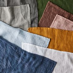 several colors of linens laid out on top of each other