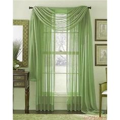 a green curtain hanging in front of a window