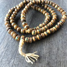 Unique and powerful Nepali Yak Bone Mala. Each bead has bras and small stone details. A unique unisex piece that will be perfect for your day by day outfits. The Mala is 40.6cm- 16 inch long A most have addition to your jewelry collection. Enjoy Con salud Holistic Style Necklace With Wooden Beads, Holistic Festival Necklaces With Wooden Beads, Holistic Style Necklace With Wooden Beads For Gifts, Holistic Necklaces With Wooden Beads For Festivals, Holistic Wooden Beads Necklace As A Gift, Holistic Style Wooden Beads Necklace For Gifts, Holistic Wooden Beads Necklace For Gift, Bohemian Round Brown Beads, Bohemian Festival Mala With Wooden Beads