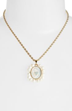 Bezel-set mother-of-pearl is carved at the center of this elegant necklace beaming with cultured pearls. 16" length; 1"W x 1 1/4"L pendant 18k gold/14k-gold plate/cultured pearl/mother-of-pearl Made in the USA of imported materials Anniversary Mother Of Pearl Jewelry With Pearl Chain, Anniversary Pearl Pendant Necklace In Mother Of Pearl, Anniversary Necklace With Pearl Pendant In Mother Of Pearl, Anniversary Necklace With Mother Of Pearl Pendant, Gold Oval Mother Of Pearl Necklace, Gold Oval Necklace With Mother Of Pearl, Anniversary Pearl Drop Necklace In Mother Of Pearl, Oval Mother Of Pearl Gold Necklace, Luxury Mother Of Pearl Necklaces With Pearl Charm