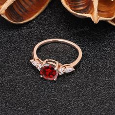 a close up of a ring with a red stone