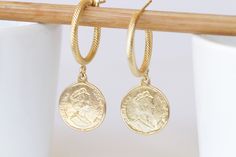 GOLD COIN EARRINGS, Coin Hoop Earrings,  Coin Jewelry,Dangle Coin Statement Earrings, Antique Coin Earrings for Women gift, Silver or Gold Details of ring: Metal: 24k gold plated \ antique silver plated Diameter of coin is 0.6 inch Adjustable ring The ring will package in a gift box Details of earrings:  Metal: 24k gold plated \ antique silver plated Diameter of coin is 0.6 inch Diameter of the hoop is 0.8 inch The rearrings will package in a gift box TO GET TO MY ETSY SHOP: https://www.etsy.com Gold-tone Huggie Earrings Gift, Gold-tone Drop Huggie Earrings As A Gift, Hallmarked Gold Huggie Earrings For Gift, Gold Plated Hallmarked Hoop Earrings As Gift, Gold Hallmarked Huggie Earrings For Gifts, Handmade Gold Brass Huggie Earrings, Gold Coin Pendant Earrings, Handmade Gold Huggie Earrings In Brass, Handmade Gold Dangle Huggie Earrings